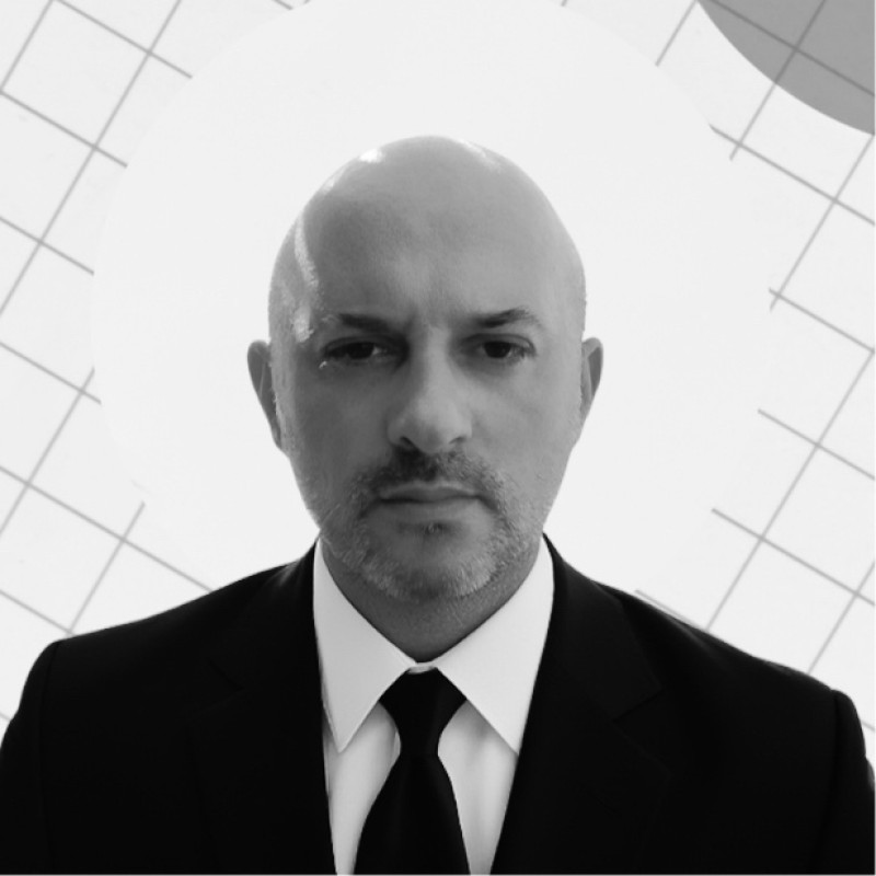 Professional portrait of Omer Hakan Ozer in a suit looking confident